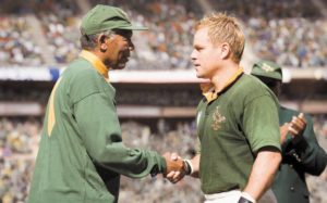 Morgan Freeman shakes hands with Matt Damon on the rugby pitch in Clint Eastwood's Invictus.