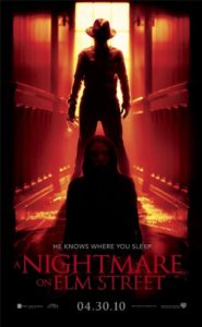 2010 Nightmare on Elm Street poster with Freddie Kreuger standing in a lit doorway casting a shadow on Nancy