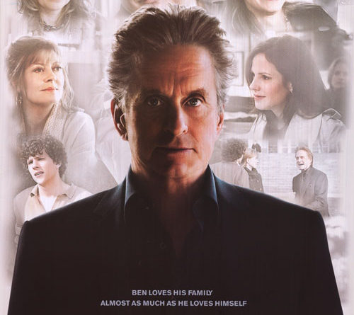 Michael Douglas stands alone with other actors are fuzzy in the background on the poster for the movie Solitary Man