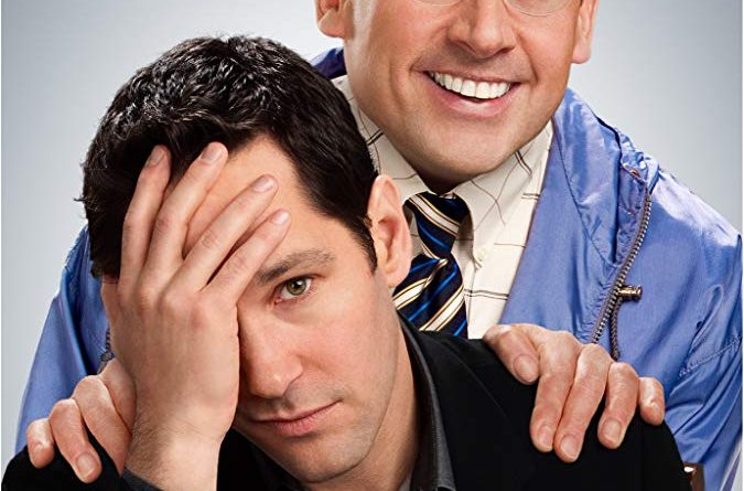 The poster for Dinner for Schmucks with Paul Rudd sitting with his hand on his head and Steve Carell grinning behind him with hands on Rudd's shoulders