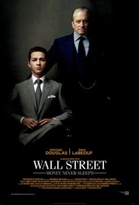 The poster for Wall Street Money Never Sleeps with Shia LaBeouf sitting in a suit and Michael Douglas standing in a suit with a hand on his shoulder