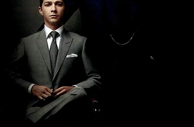 The poster for Wall Street Money Never Sleeps with Shia LaBeouf sitting in a suit and Michael Douglas standing in a suit with a hand on his shoulder