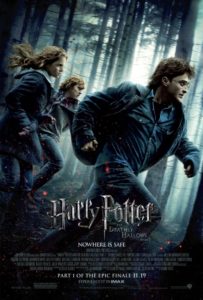 The poster for Harry Potter and the Deathly Hallows Part 1 with Emma Watson, Daniel Radcliffe and Rupert Grint running frantically through a forest