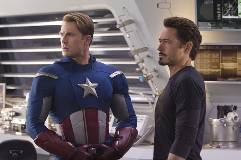 Chris Evans and Robert Downey Jr. looking to the left and listening in The Avengers