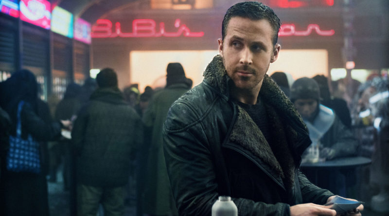 Ryan Gosling gives the side eye at an outdoor market in Blade Runner 2049.
