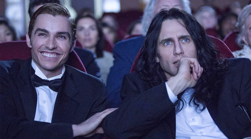 Dave Franco laughing and James Franco looking concerned in a theatre during The Disaster Artist, where Dave plays Greg Sestero and James plays Tommy Wiseau.