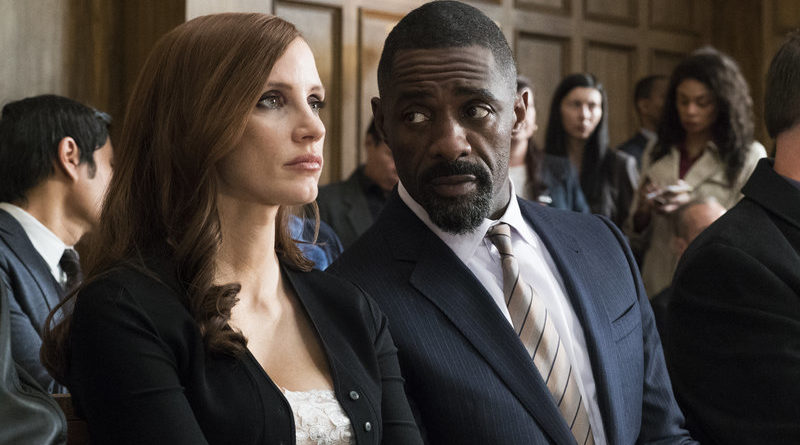 Jessica Chastain and Idris Elba speak quietly while awaiting their moment in court in Molly's Game.