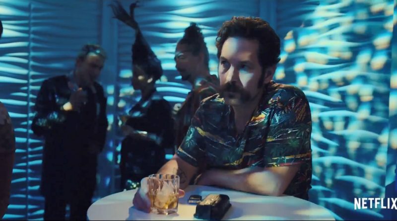 Paul Rudd sitting toughly at a nightclub in the movie Mute.