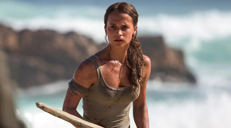 Alicia Vikander wielding a spear on an island beach in Tomb Raider.
