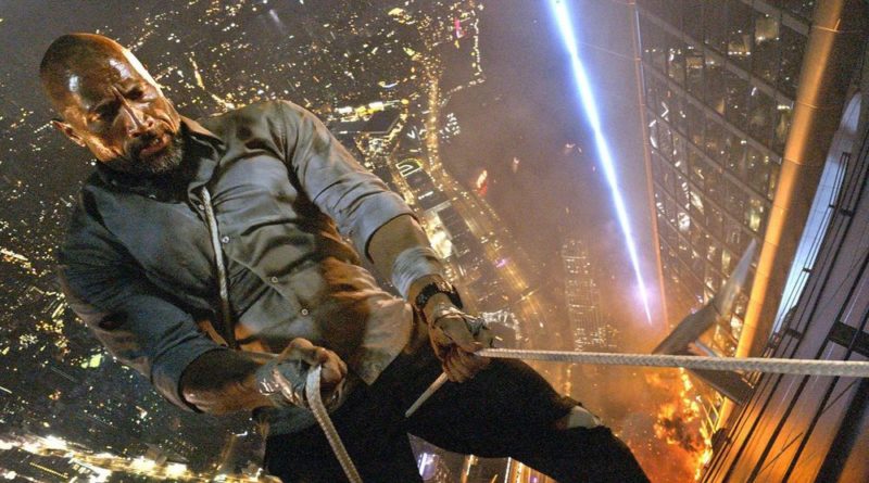 Dwayne Johnson repels down a building with a cable in Skyscraper