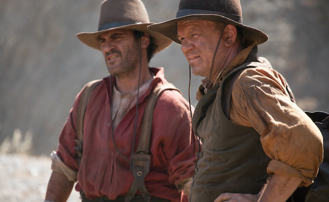 Joaquin Phoenix and John C. Reilly in the Western film The Sisters Brothers looking at something off camera