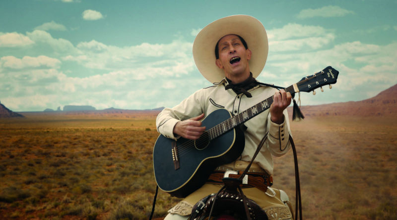 Tim Blake Nelson on a horse wearing white playing a guitar and singing in front of a picturesque landscape in the film The Ballad of Buster Scruggs