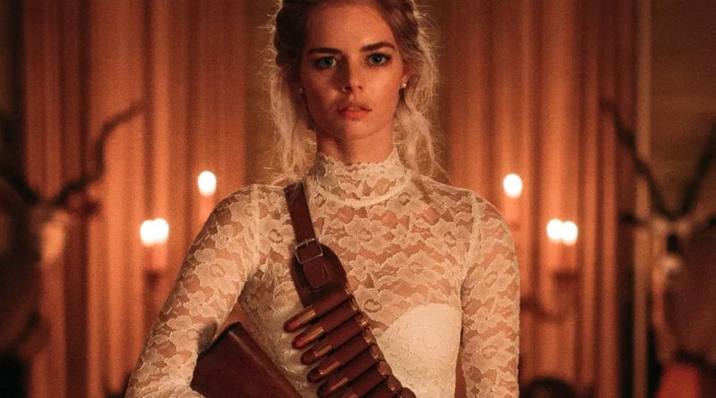 Samara Weaving in a wedding dress and a bandolier holding a shotgun from the movie Ready or Not