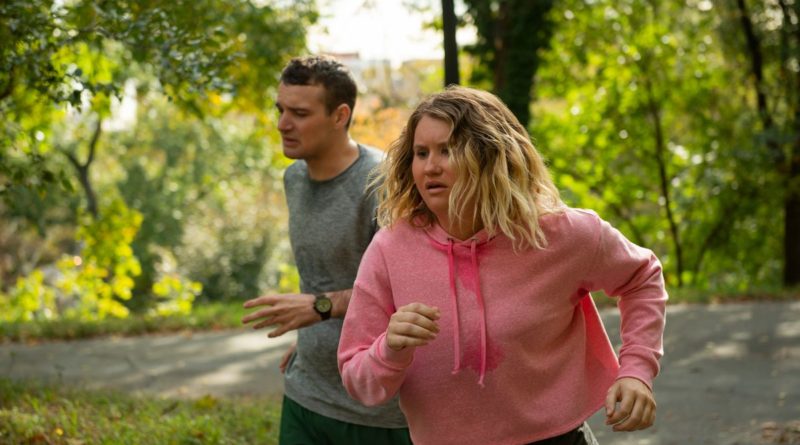 Jillian Bell runs with a partner through a park in the movie Brittany Runs a Marathon