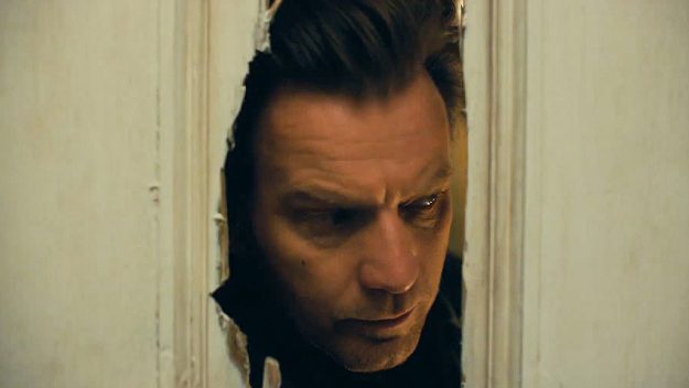 Ewan McGregor pokes his head through a hole in the door like the one in The Shining, in the movie Doctor Sleep