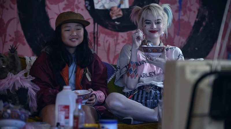 Margot Robbie eats cereal on the couch while watching TV in the movie Harley Quinn: Birds of Prey
