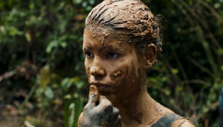 A child soldier has mud smeared on her face in the movie Monos