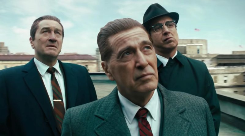 Al Pacino looks up while Robert De Niro and Ray Romano stand behind him looking up in the movie The Irishman