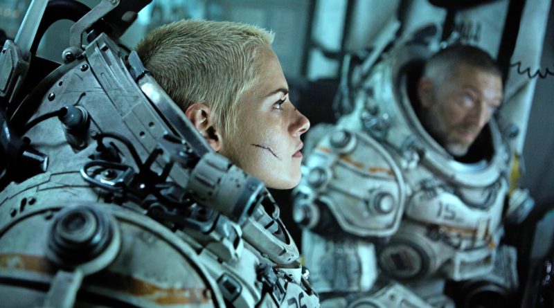 Kristen Stewart and Vincent Cassel sit in underwater suits with their helmets off in the movie Underwater