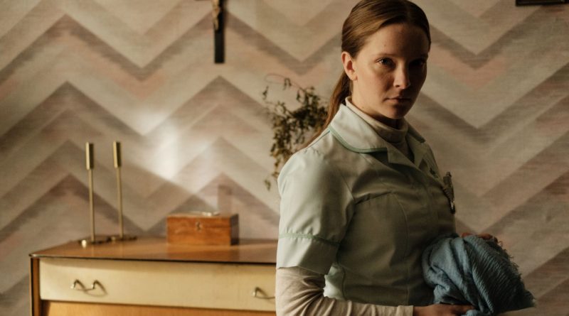 Morfydd Clark looks creepily at the camera in the horror movie Saint Maud