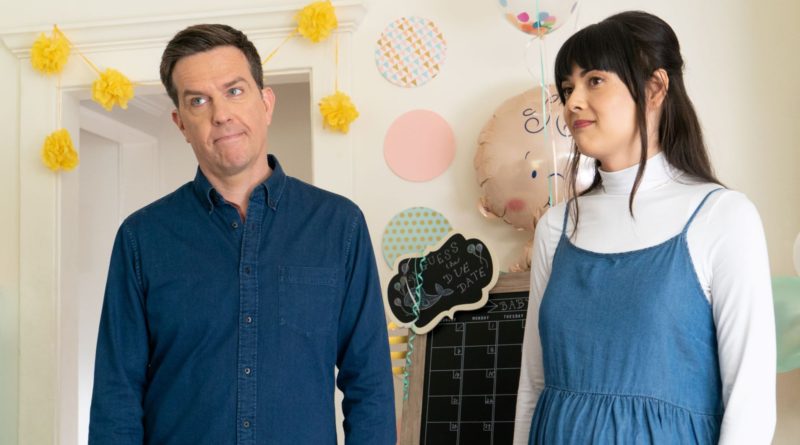 Ed Helms and Patti Harrison make goofy faces as they stand next to each other in the movie Together Together