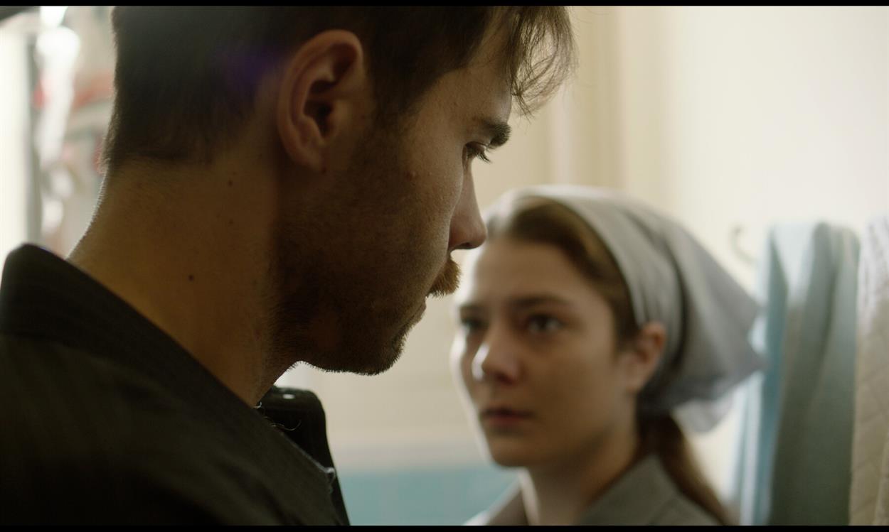 A woman looks mournfully at a man in the short film New Lives.